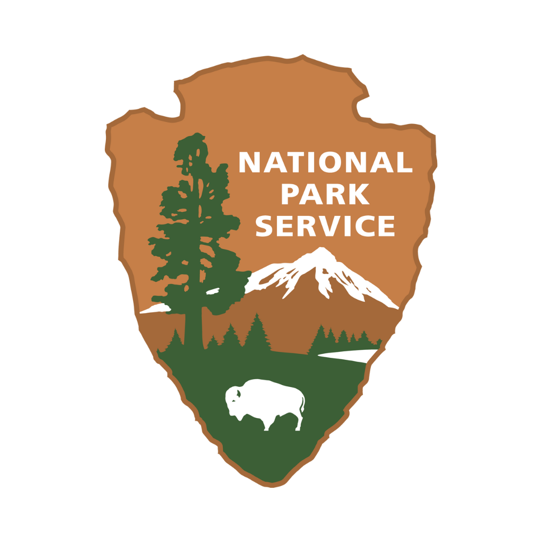 National Park Service Logo: Brown arrowhead logo, point down. At top right, white text, National Park Service. At left, a tall tree. At bottom, a white bison stands on a green field ending in a distant tree line, a white lake at right. A snow-capped mountain towers behind.